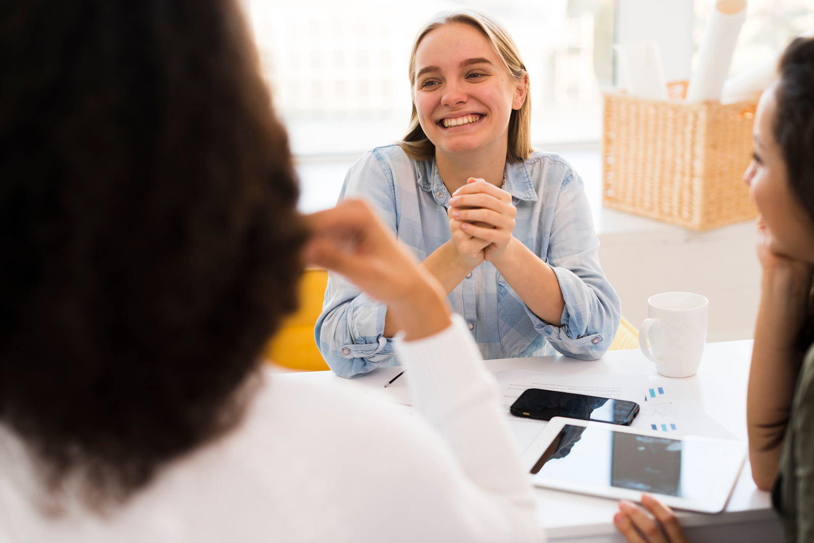 three women talking and smiling
