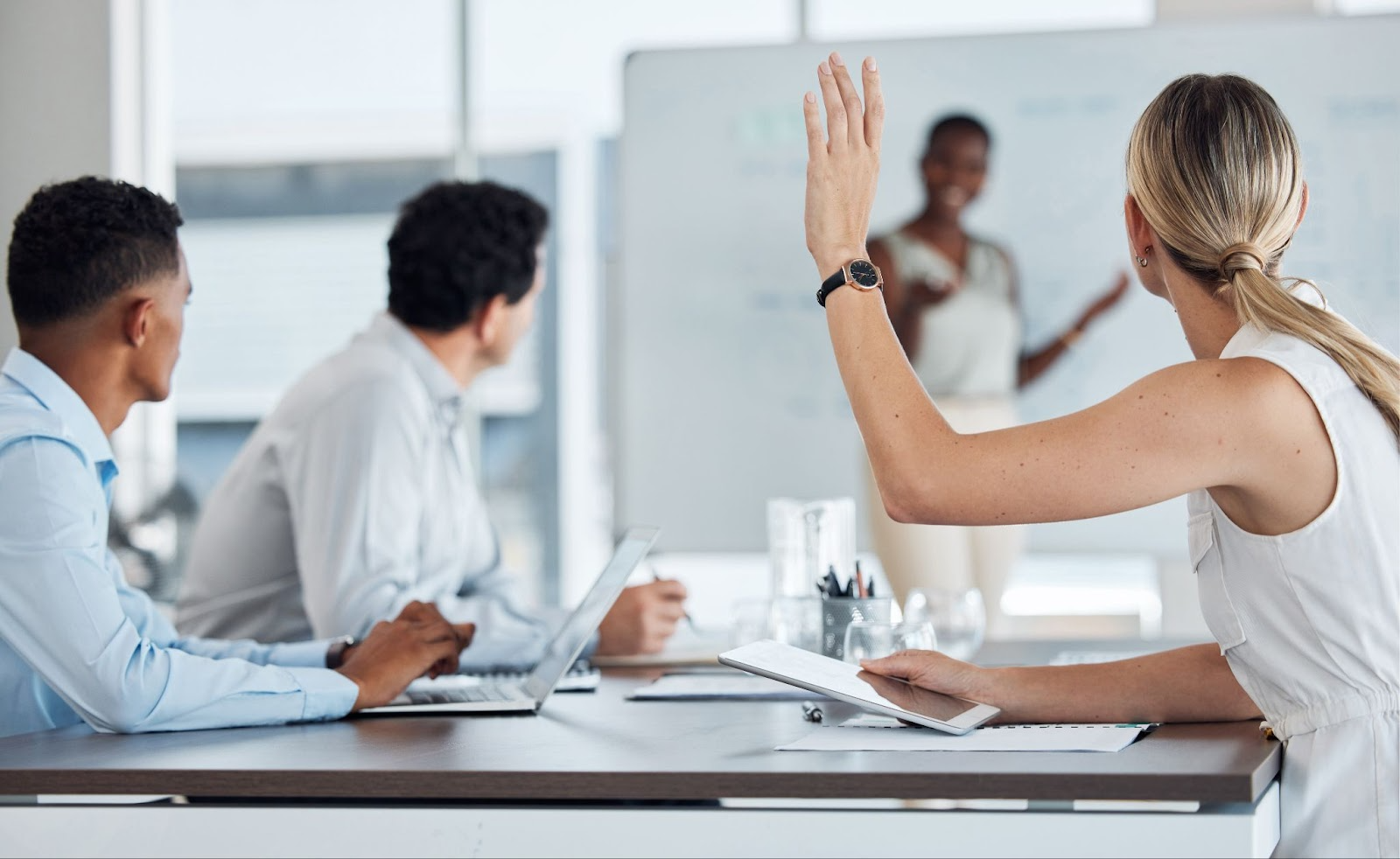 woman raising her hand in a teaching program