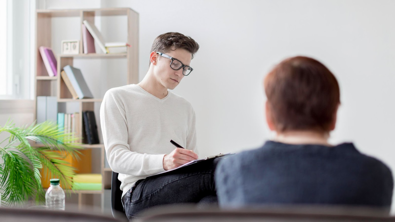 a life coach writing down the notes