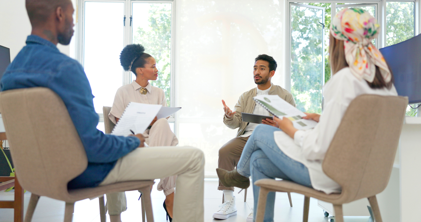 a group of people sitting in a circle and talking