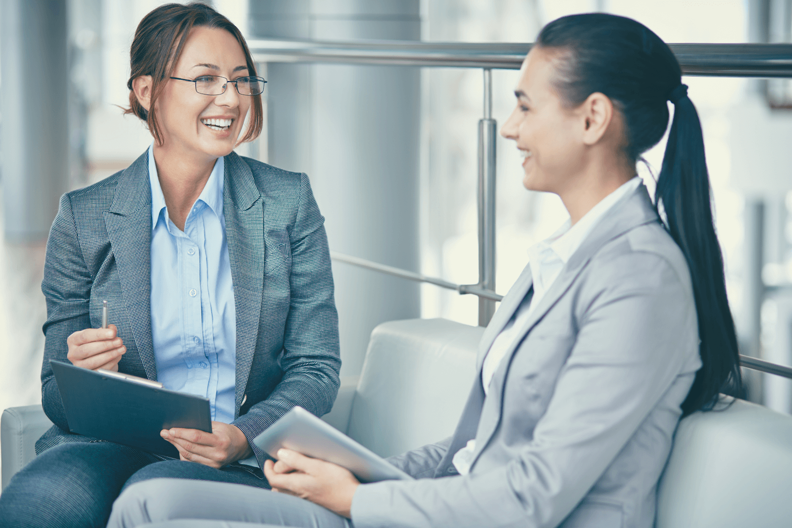 2a80a8b7-0e31-4fbe-8b51-30acd4fd4cdc (1) two business women smiling