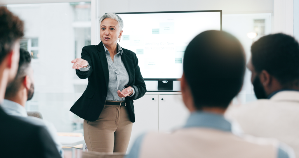 a woman standing in front of a screen