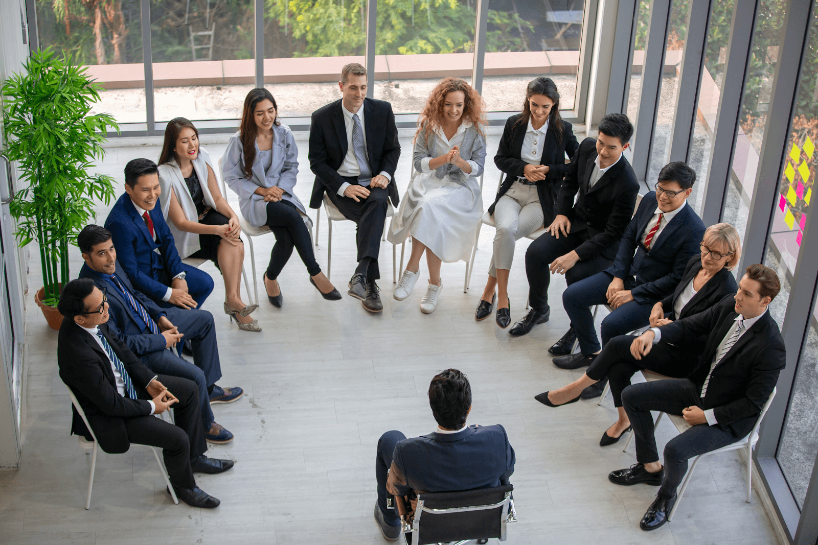 e72b7b4a-7b56-41df-86f9-392907824d85 (1) a coach and a group of people sitting in a circle